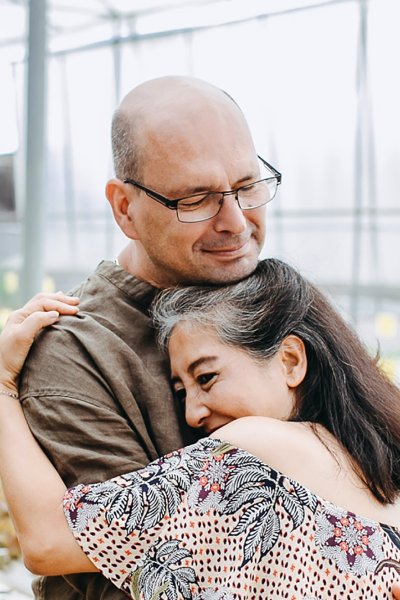 A couple embracing in a greenhouse